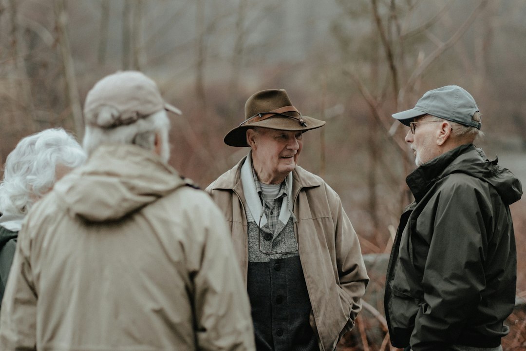 Group of smiling elderly people gathering and chatting in a bright community hall